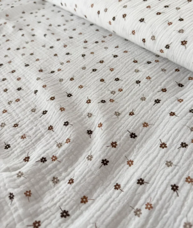 Folded floral muslin swaddle blanket flat lay – perfect baby shower gift, soft cotton newborn blanket, handmade in Lithuania
