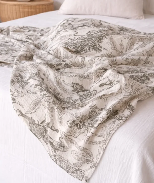 Close-up of jungle muslin swaddle blanket fabric – soft cotton weave with animal print, newborn safe, handmade